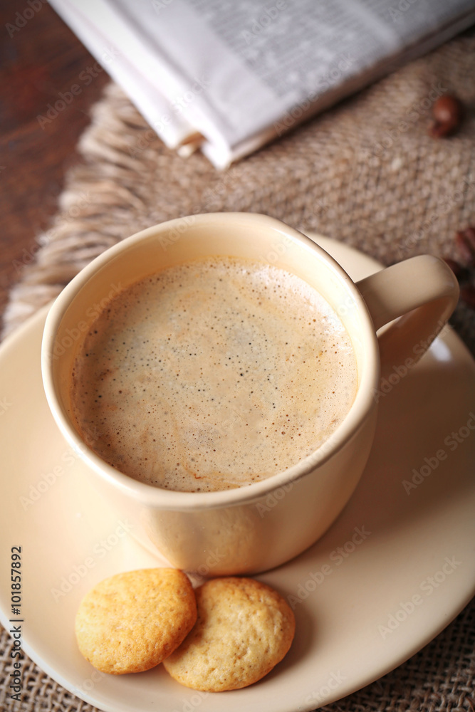 Cup of coffee, cookie and newspaper on wooden table background Cup of coffee, cookie and newspaper on wooden table background