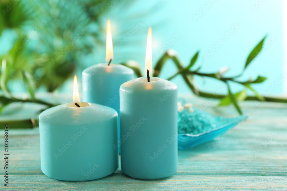 Blue candles with spa salt and bamboo on table Blue candles with spa salt and bamboo on table