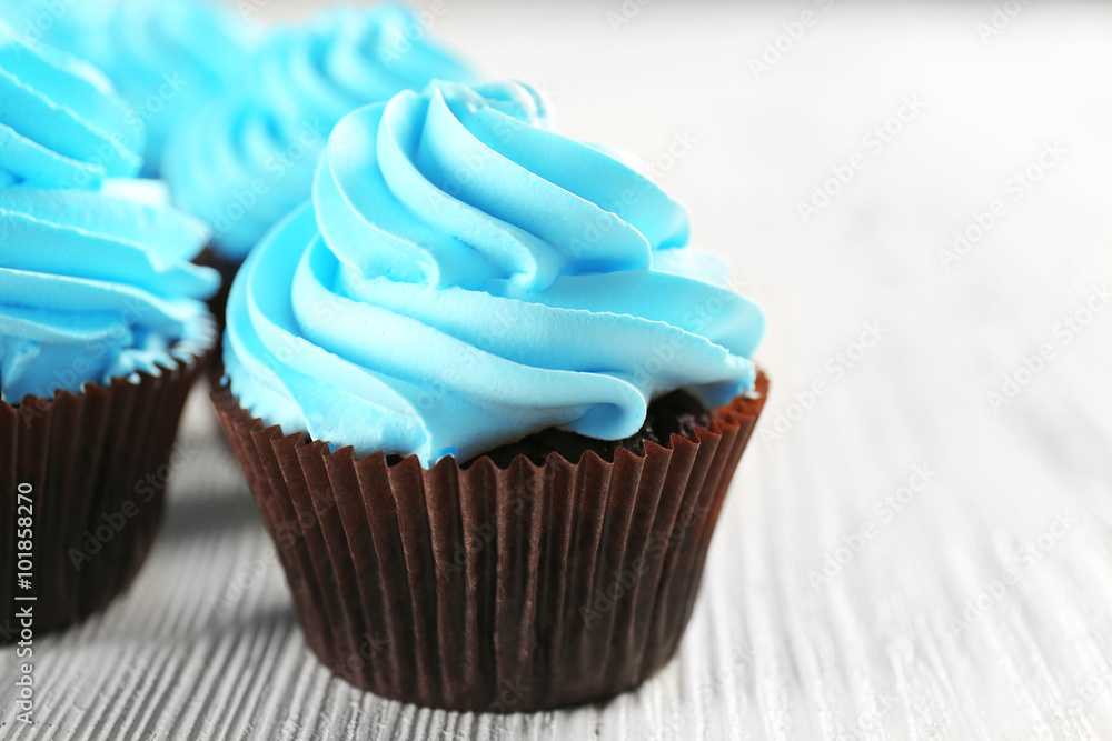 Blue cupcakes on wooden table Blue cupcakes on wooden table