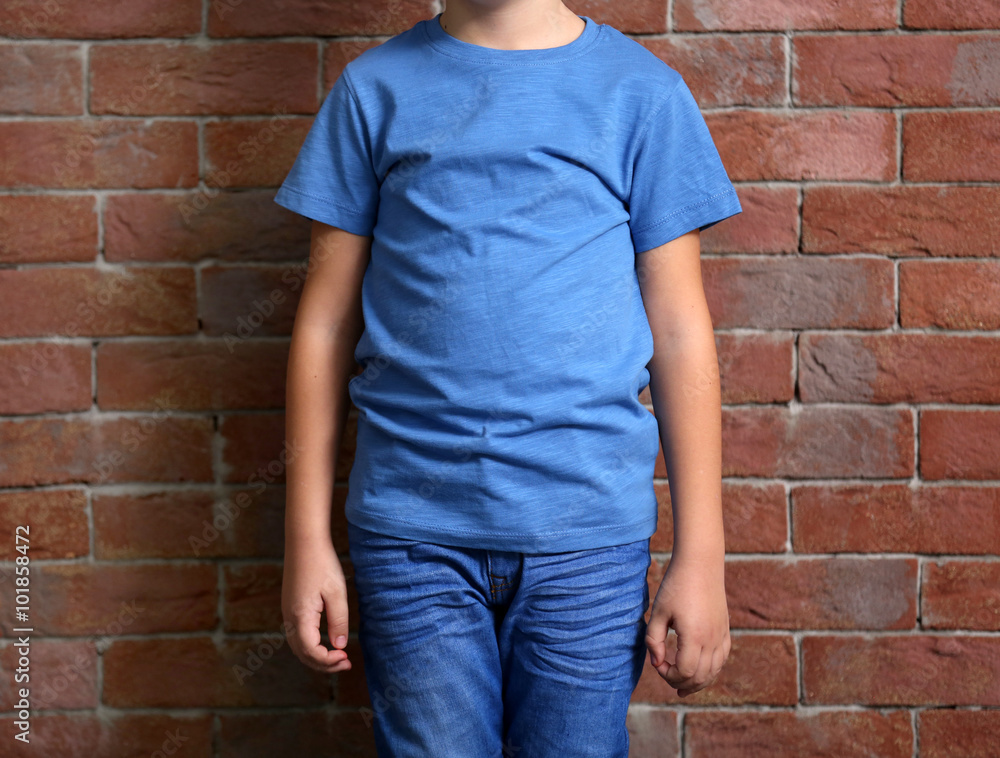 Small boy on brick wall background Small boy on brick wall background