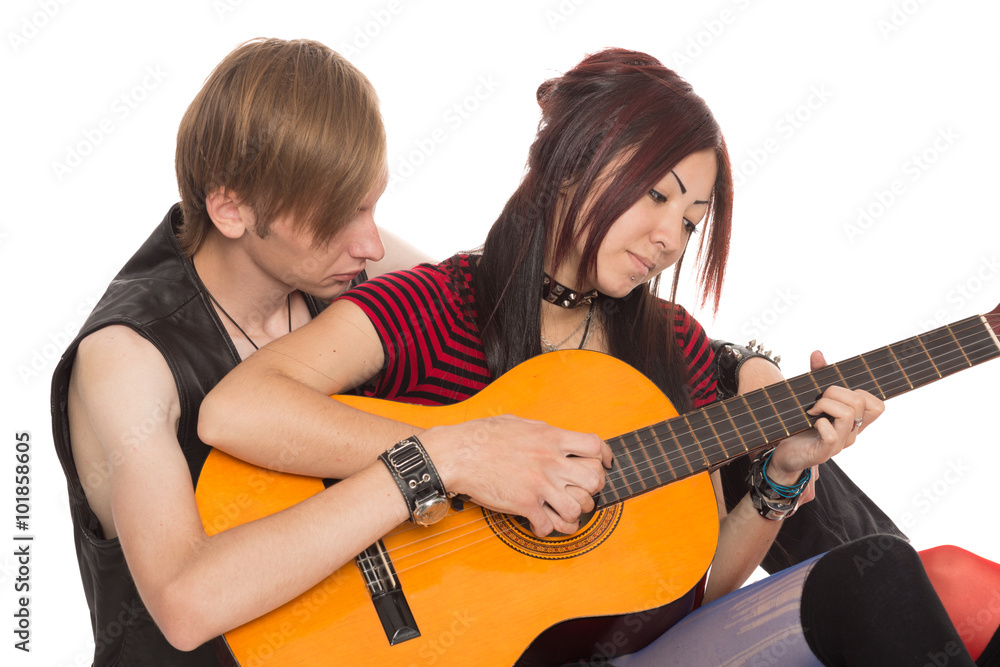 © Stanislav Komogorov - Boy teaches girl to play the guitar