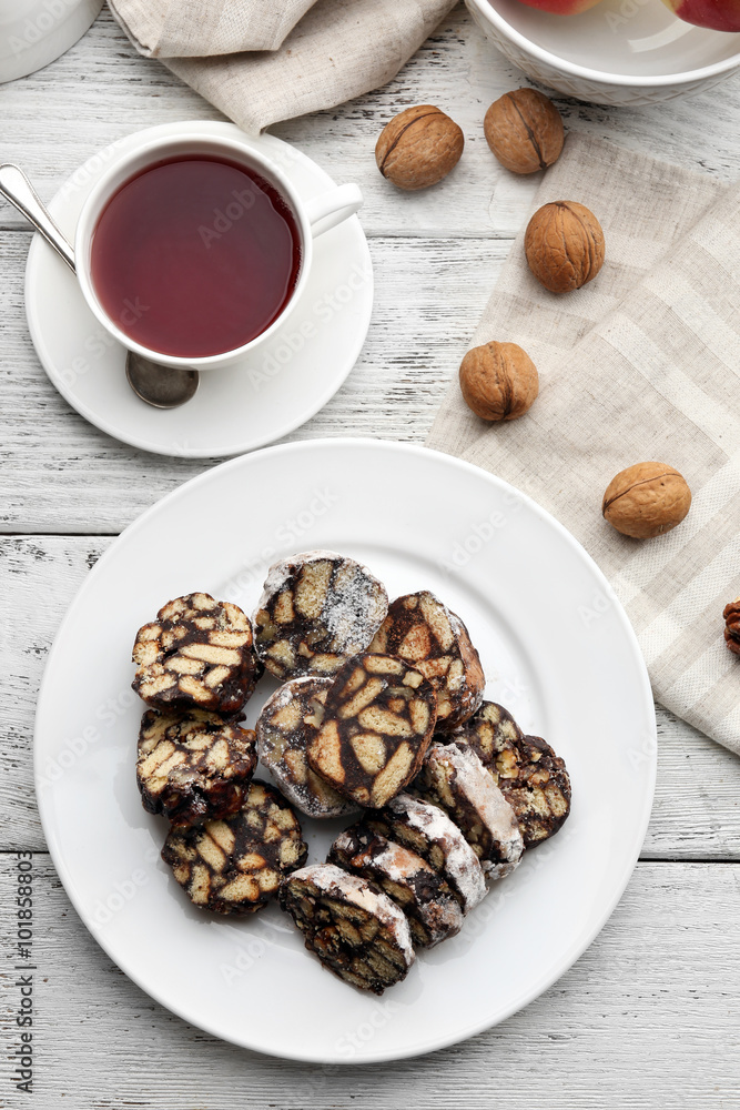 Chocolate salami in a plate over wooden background, close up Chocolate salami in a plate over wooden background, close up