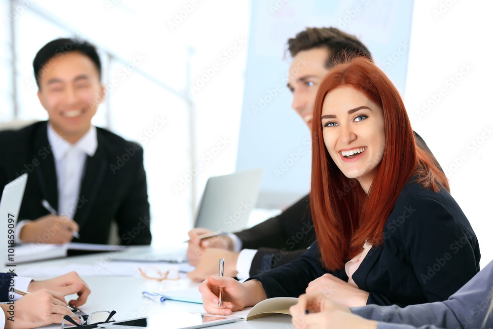 Young redhead businesswoman sitting at the office meeting Young redhead businesswoman sitting at the office meeting