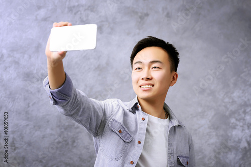 Young Asian boy taking phot...