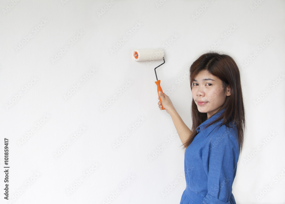 woman paints the wall