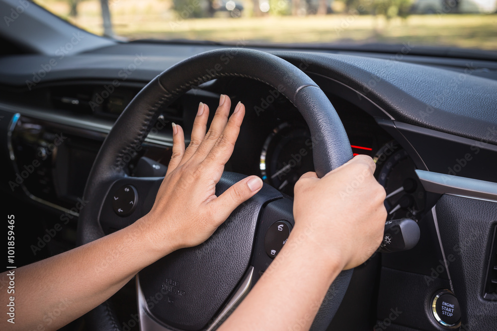 Hand of driver on steering