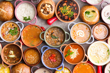 Variety of Garnished Soups in Colorful Bowls