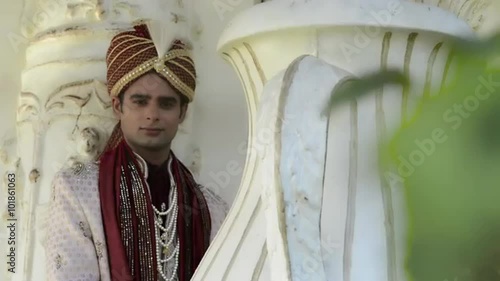 Shot of a Indian groom posing in traditional wedding dress photo