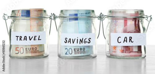 Three jars for different needs full of coins