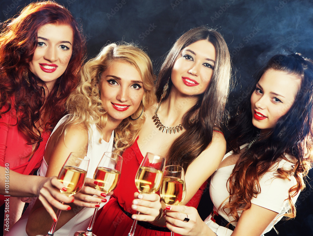 girls clinking flutes with sparkling wine girls clinking flutes with sparkling wine