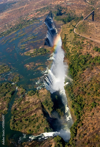 Fototapeta The Victoria falls is the largest curtain of water in the world. The falls and the surrounding area is the Mosi-oa-Tunya National Parks and World Heritage Site (helicopter view) - Zambia, Zimbabwe