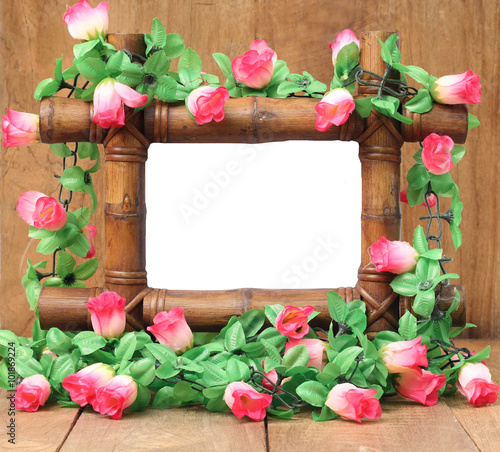 Fototapeta Naklejka Na Ścianę i Meble -  Bamboo frame with roses on a white background.