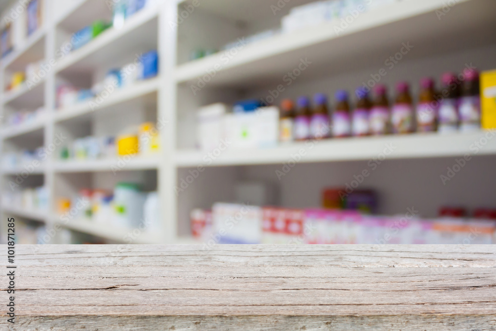 wood counter with blur shelves of drugs in the pharmacy