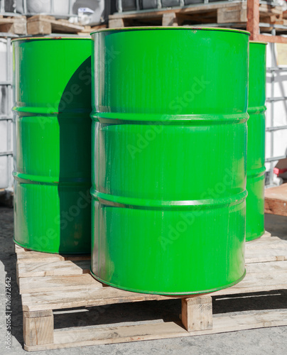 Green barrels on wooden pallets