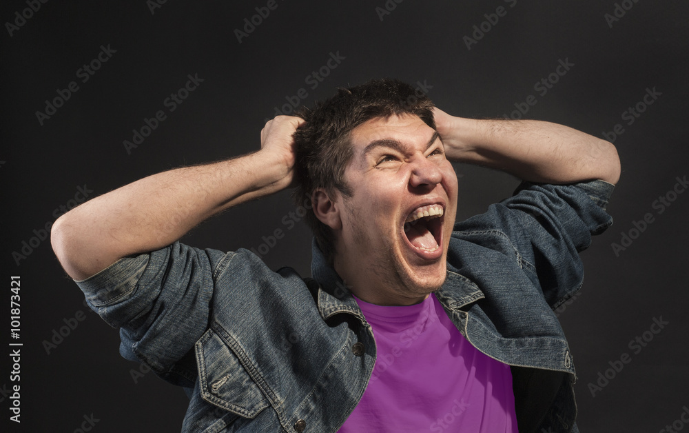 Close-up of a man screaming in agony.