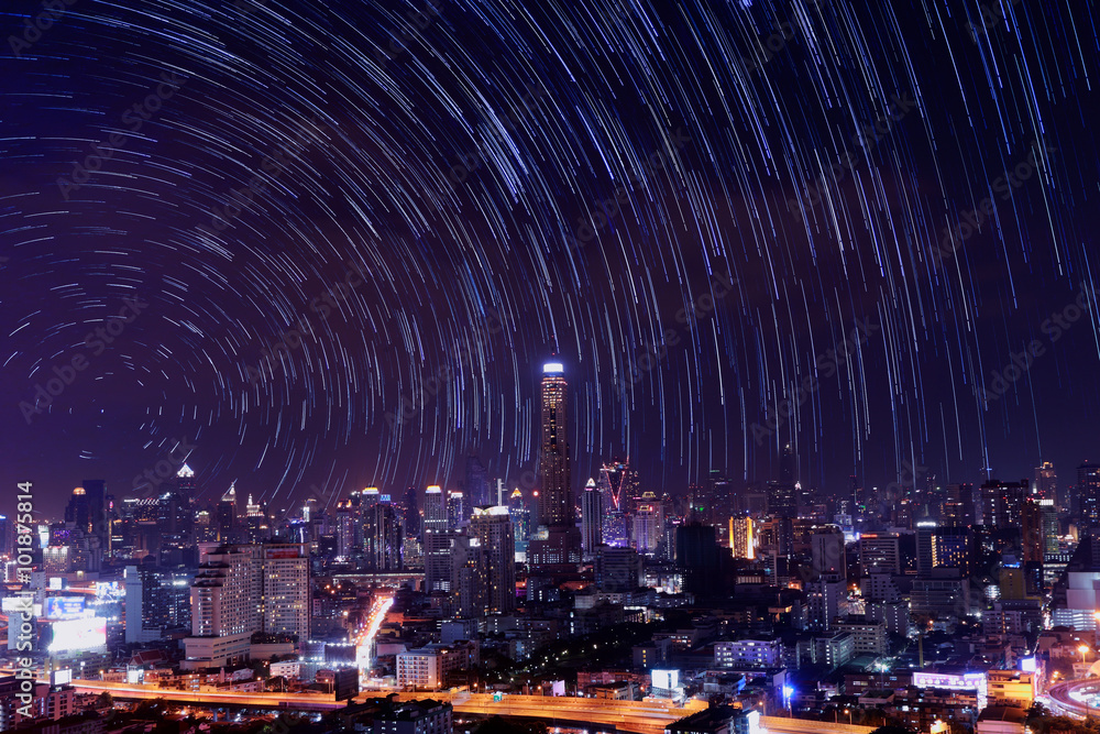 The night sky , the stars and the Tallest building in the city.