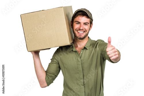 Handsome postman holding pack showing thumbs up photo