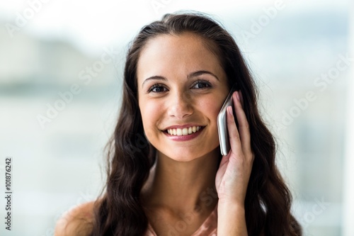 Smiling woman on phone call looking at camera