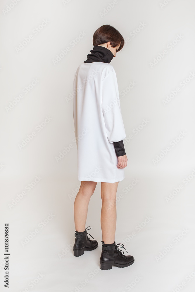 Stylish girl model in clothes. White background. Stylish girl model in clothes. White background.