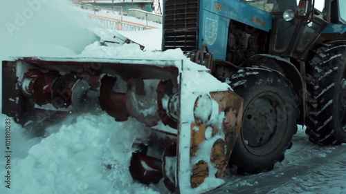 Snowplow removes a lot of snow. Close-up. photo