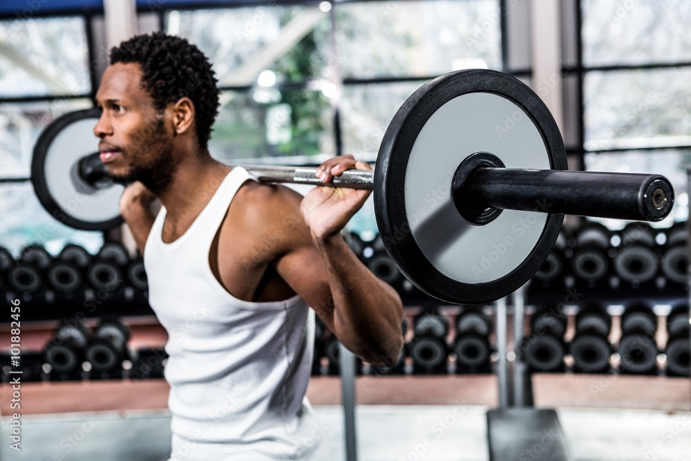 Muscular man exercising with barebell Muscular man exercising with barebell