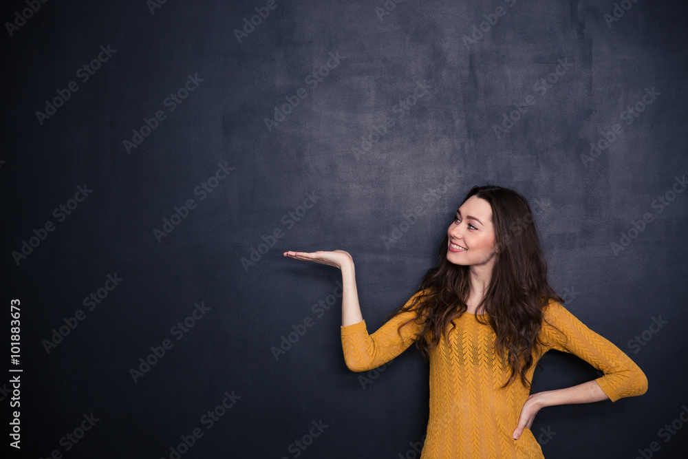 Happy woman holding copyspace on the palm Happy woman holding copyspace on the palm