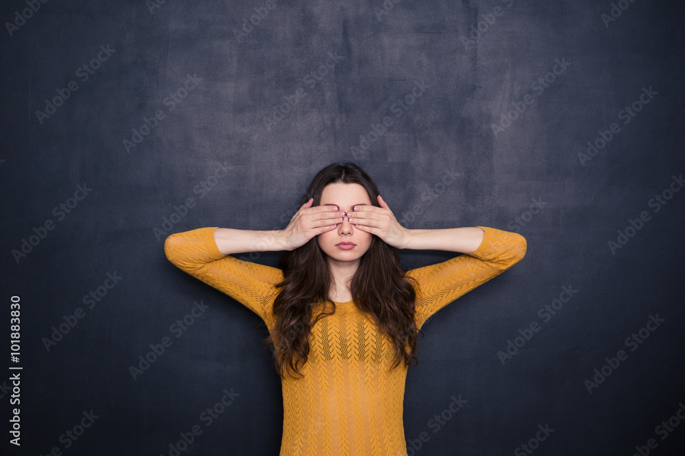 Young woman covering her eyes Young woman covering her eyes
