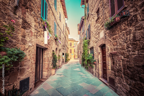 Narrow street in an old Italian town of Pienza. Tuscany, Italy. Vintage
