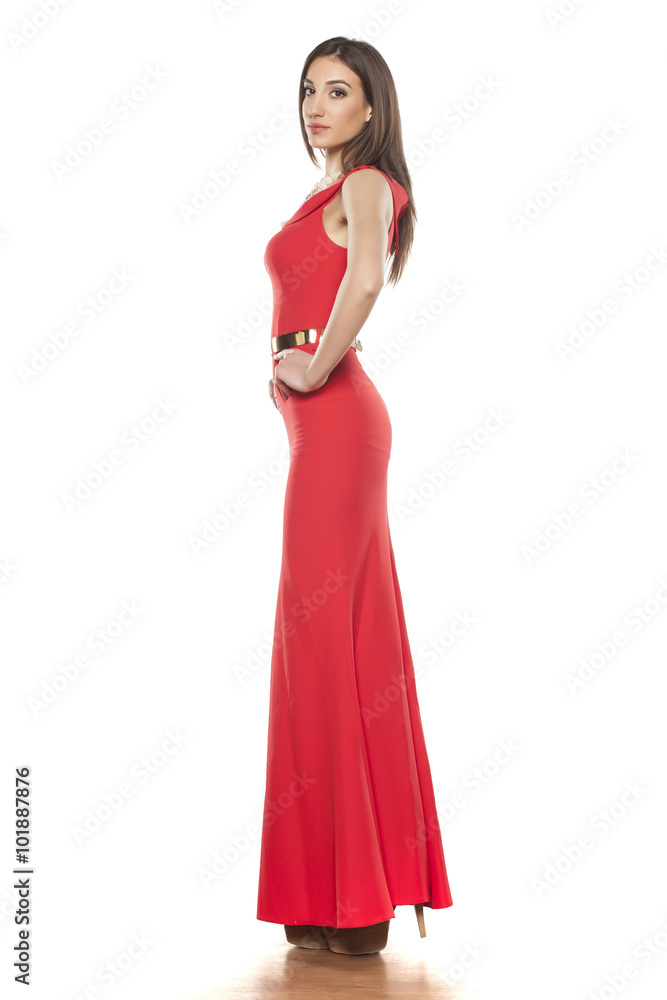 young elegant woman posing in red evening dress