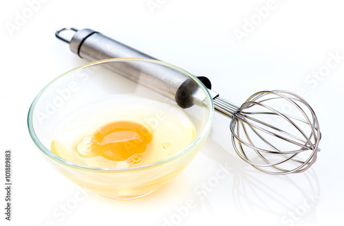 beaten egg in bowl and hand mixer