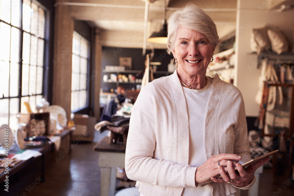 Portrait of owner of gift store with digital tablet Portrait of owner of gift store with digital tablet