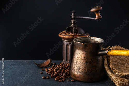 Coffee mill and cezve on the dark table horizontal photo