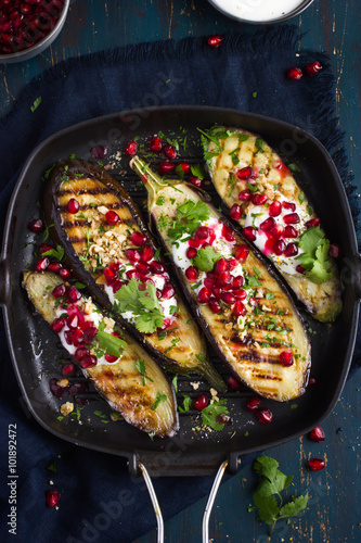 grilled eggplants with garlic yogurt sauce, walnuts and pomegran photo