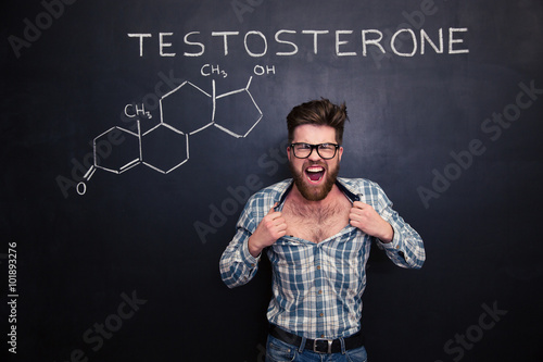 Tableau sur toile Aggressive man in glasses screaming and tearing off his shirt