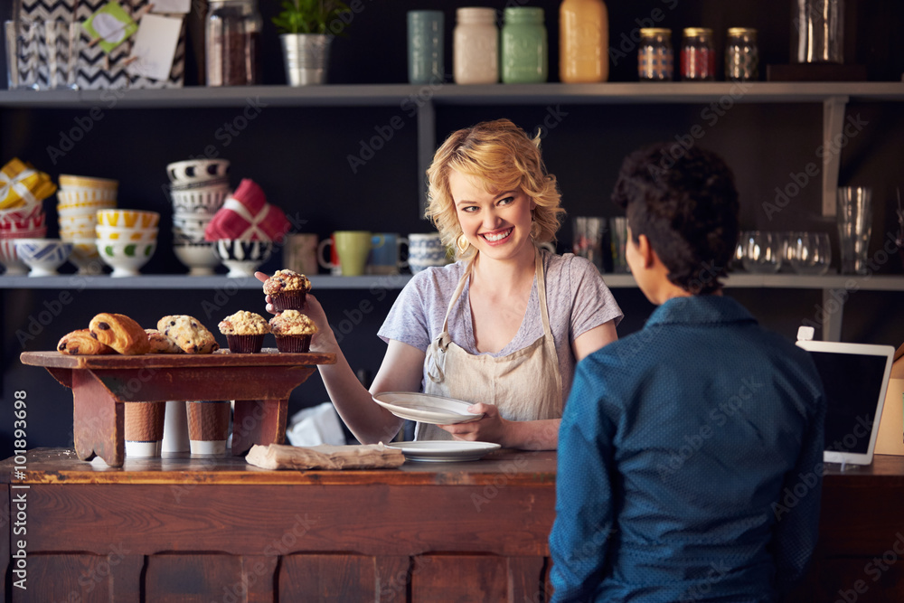 Staff Serving Customer In Busy Coffee Shop Staff Serving Customer In Busy Coffee Shop