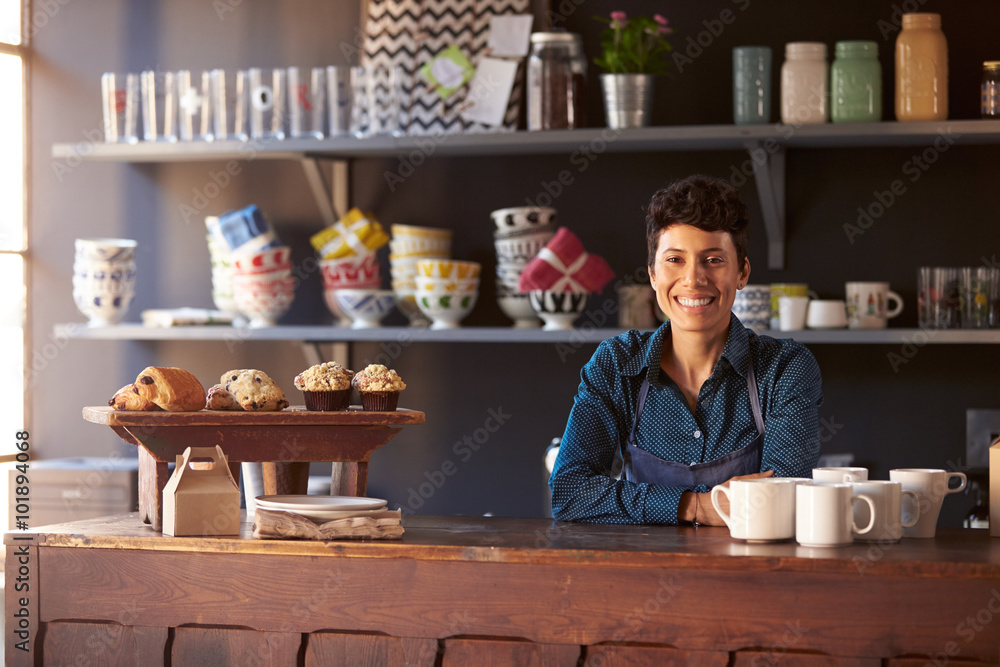 Portrait Of Female Coffee Shop Owner Standing Behind Counter
