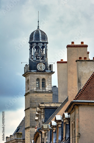 Townhouses and belfry with a clock in Dijon, France.