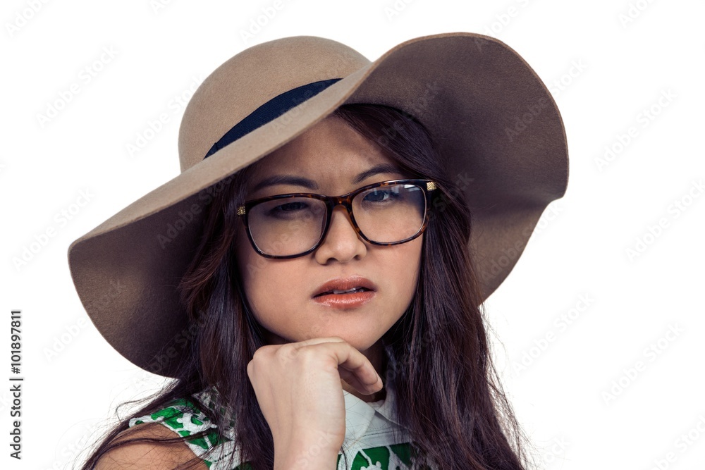 Asian woman with hand on chin wearing hat Asian woman with hand on chin wearing hat