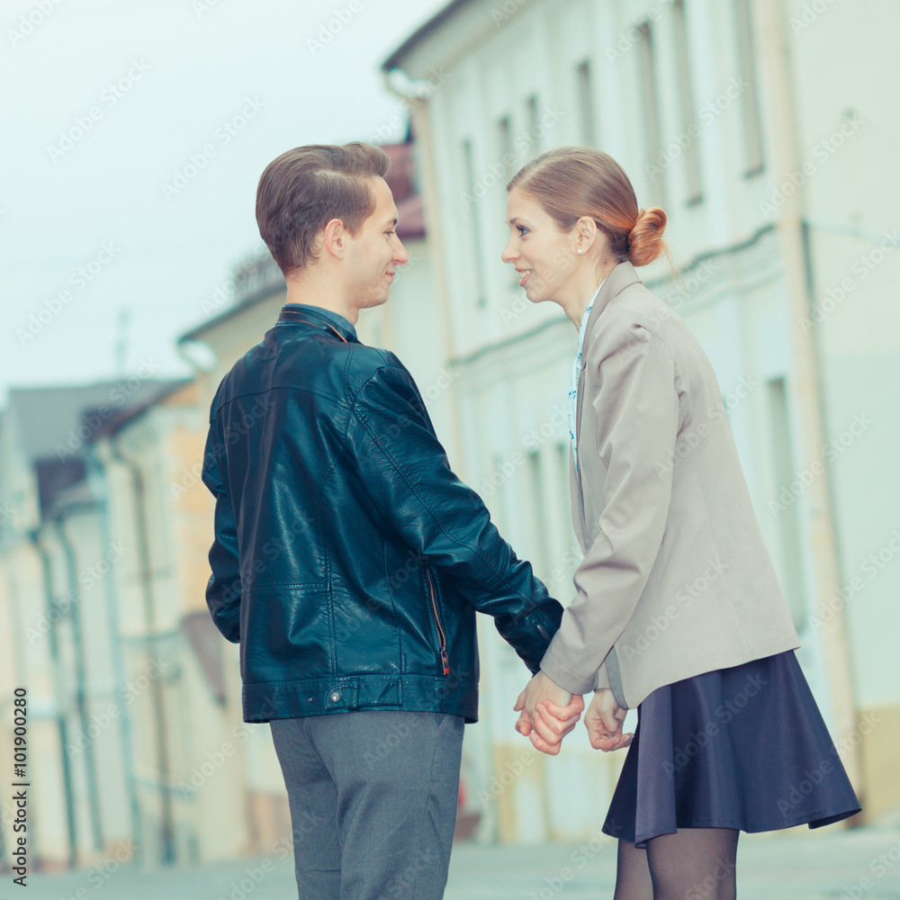 Obraz premium Stylish young hipster couple cuddling on the streets. Stylish young hipster couple walking down the street. vintage toning