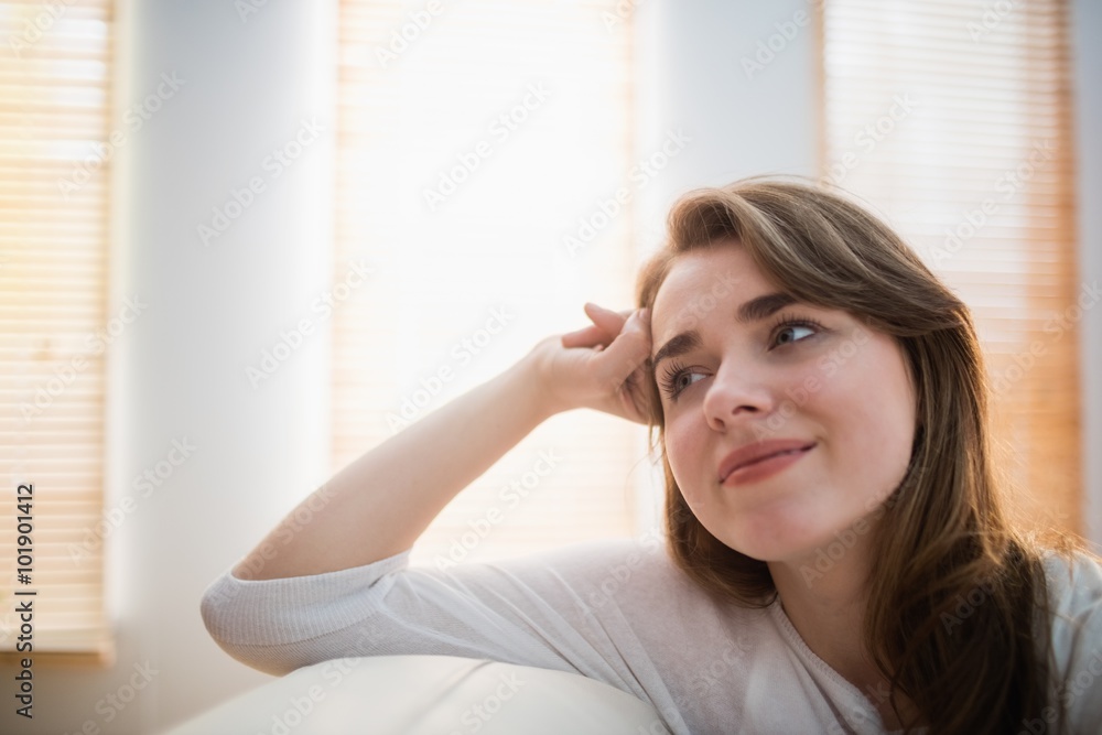 Smiling woman posing on the couch Smiling woman posing on the couch