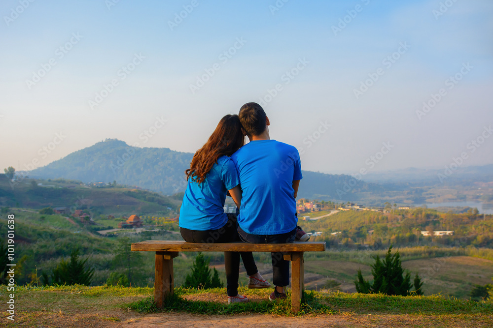 Scene of romantic and happy young romantic couple sitting with natural background.Love concept.