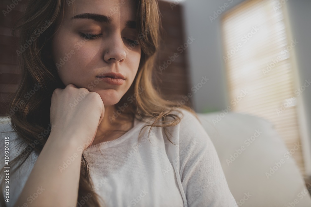 Upset woman sitting on the couch Upset woman sitting on the couch