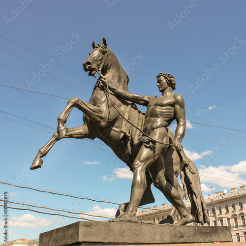 Sculpture of a man with a horse next to Anichkov Bridge.