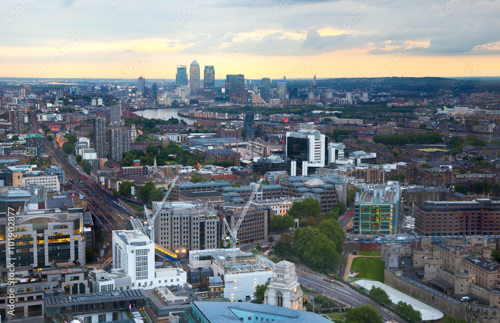 London at sunset, aerial view includes famous buildings, streets and Canary Wharf aria at distance 