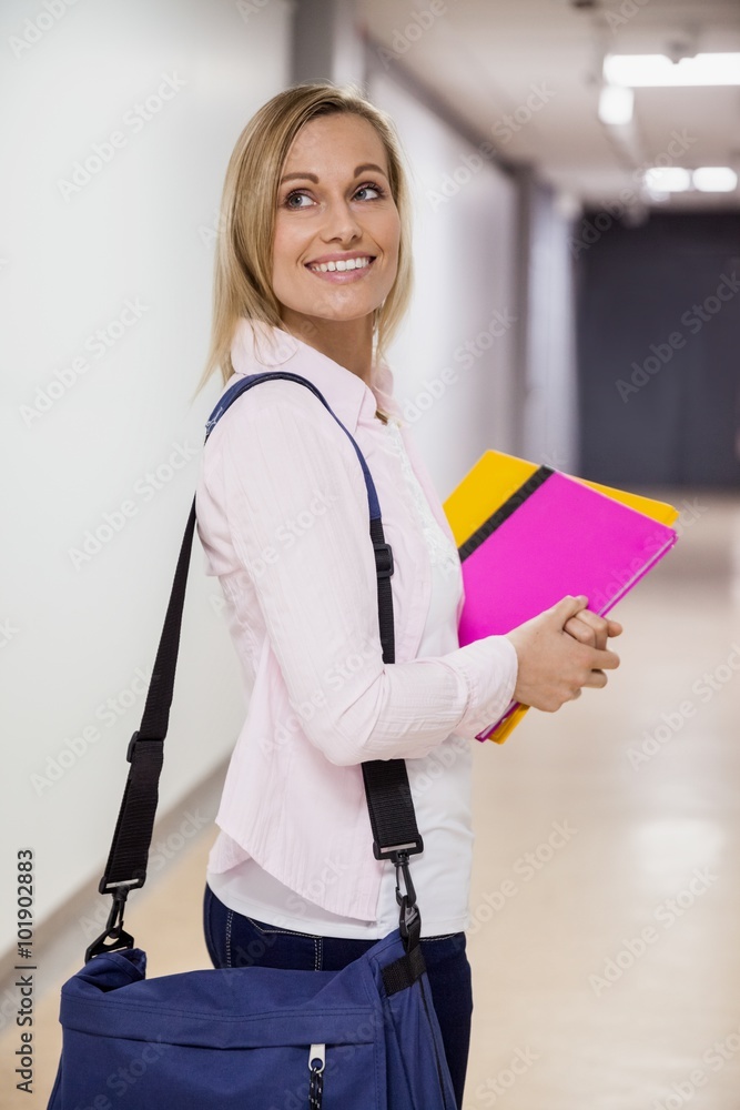 Happy female student walking in the hallway Happy female student walking in the hallway