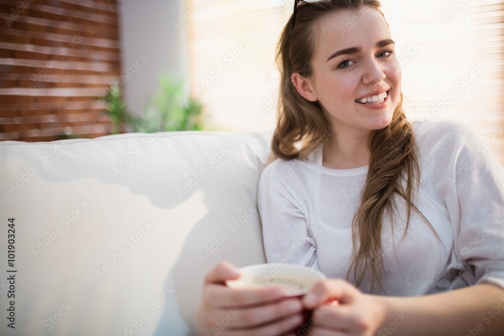 Pretty woman relaxing on couch with coffee Pretty woman relaxing on couch with coffee