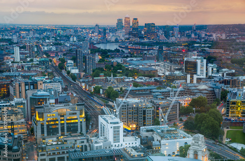 London at sunset  aerial view includes famous buildings  streets and Canary Wharf aria at distance 