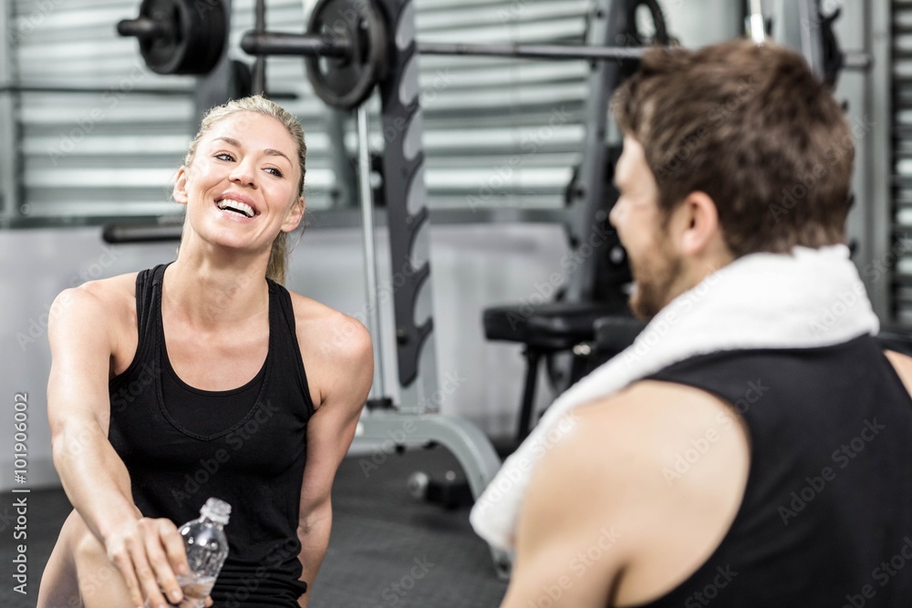 Fototapeta premium Smiling fit couple sitting 