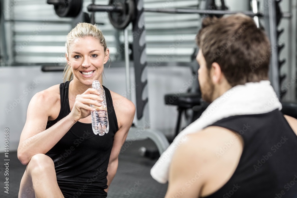Smiling fit couple sitting Smiling fit couple sitting