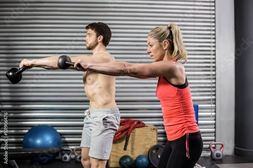 Couple lifting dumbbells together